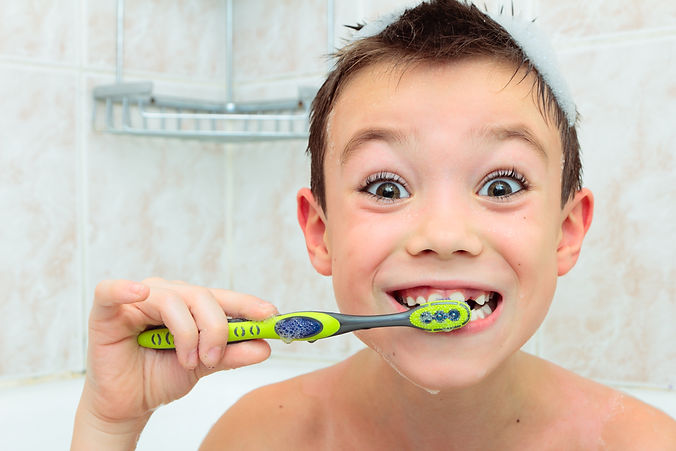 child brushing his teeth