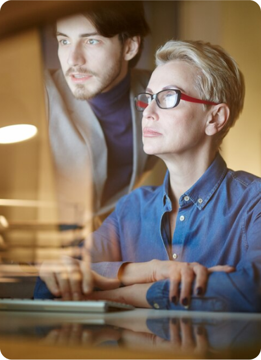 Focused colleagues collaborate on computer screen