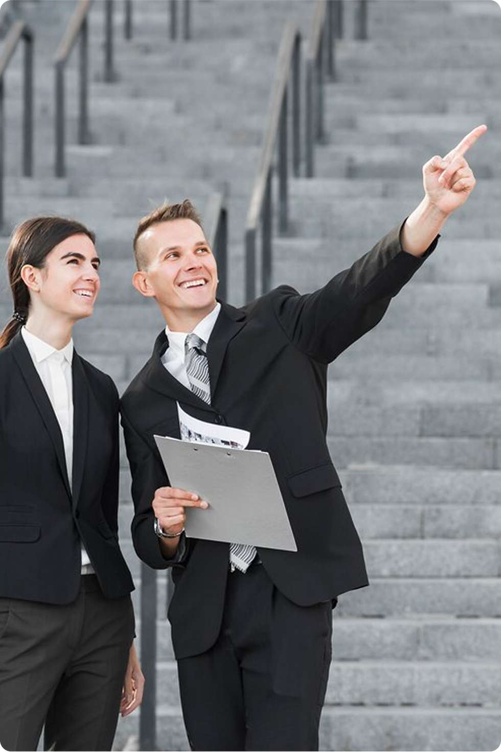 Businesspeople reviewing documents, pointing upward, strategic planning