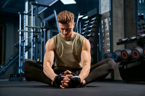 Hardcore Gym member stretching