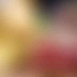 A wooden cutting board with a variety of deli meats and cheeses.