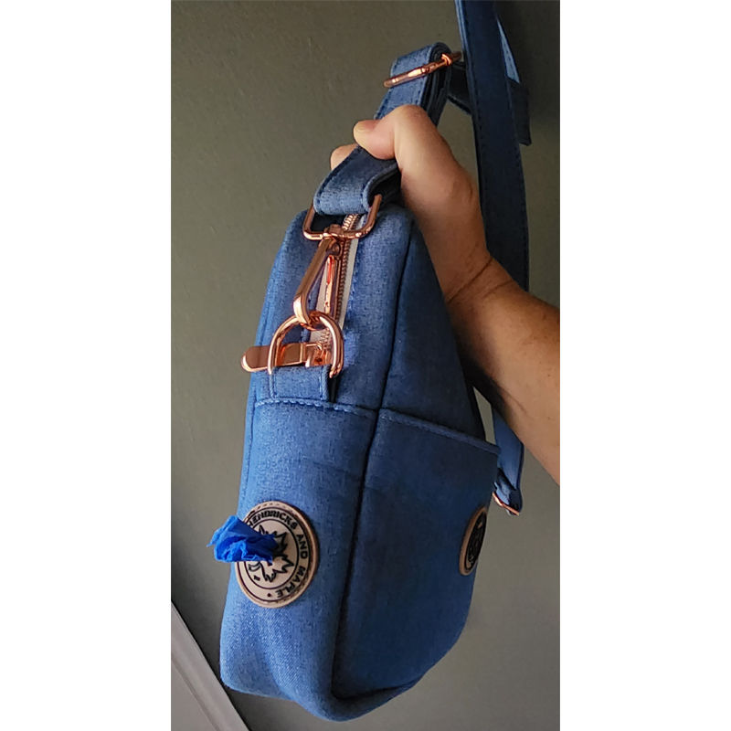 View of the side bag dispenser inside the Hendricks and Maple logo on the indigo denim walkies bag.