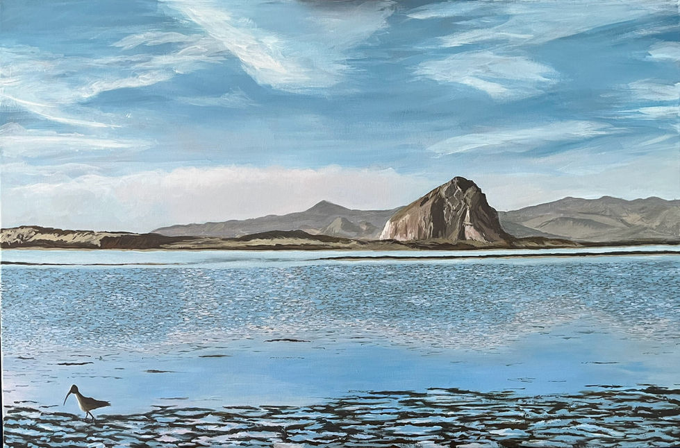 Painting of Morro Bay. Small bird on beach in foreground with muddy pools. Stretch of blue water in front of Morro Rock and the surrounding hills. Sky has light, airy clouds.