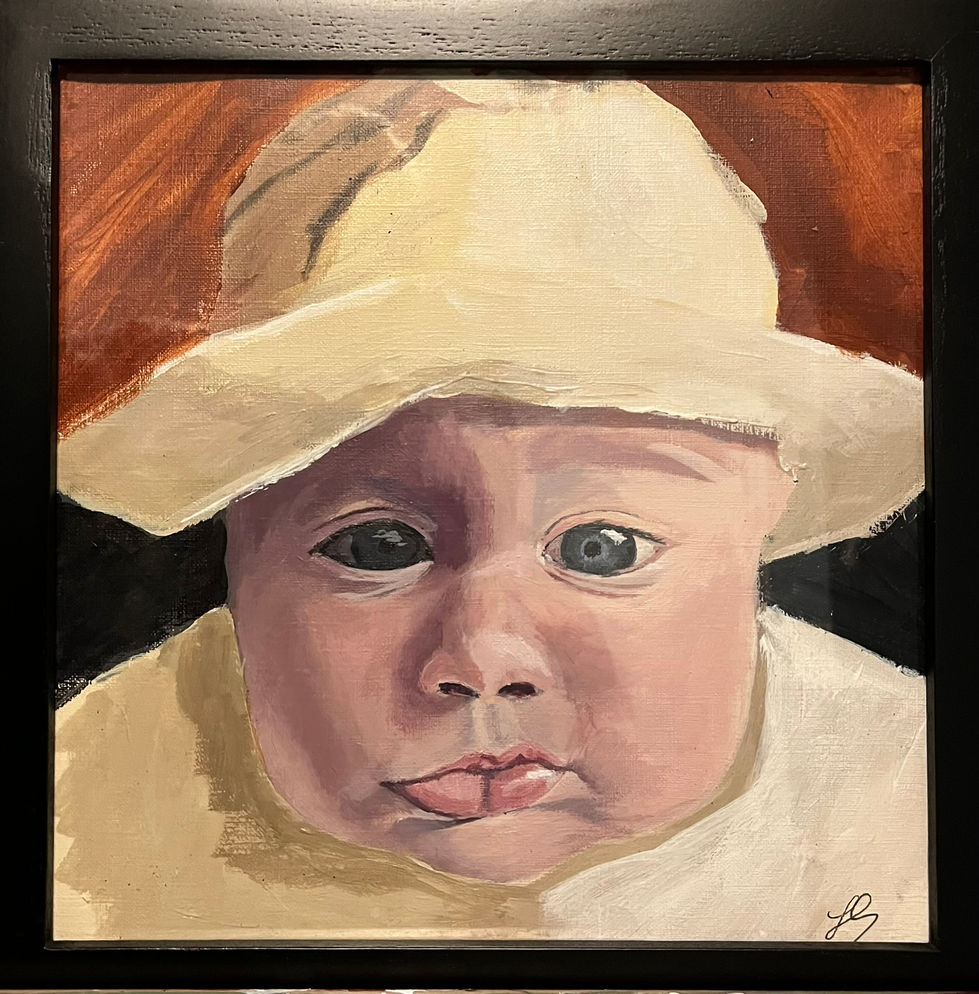 Close up portrait of a baby wearing a tan hat. Lips pouting, wide eyes. Brown background.