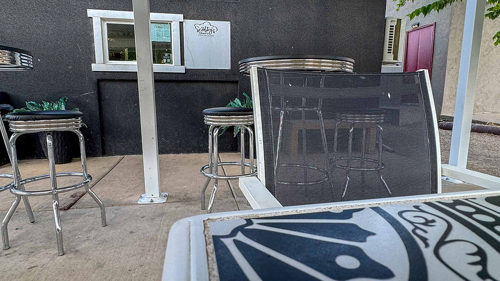Outside patio area on Scotty's Diner with stools, chairs, and tables.