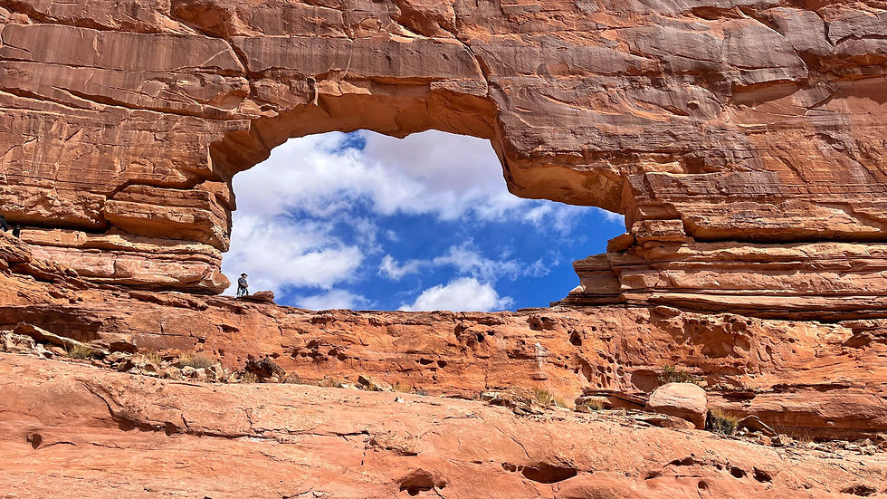 An arch in the shape of a Jeep in the red rocks walls of Moab, Utah.