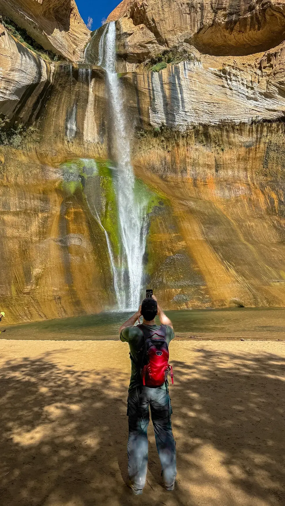Jordan taking a picture of the waterfall
