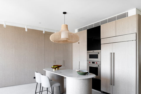 Modern kitchen with island bench and woven pendant light. Modern kitchen featuring a marble island, light timber cabinetry and woven pendant lighting. Contemporary kitchen with minimalist timber cabinetry, stone island bench and pendant lighting. Sleek modern kitchen with custom timber joinery, integrated appliances and sculptural pendant light. Designer kitchen with stone island, built-in appliances and natural timber finishes.