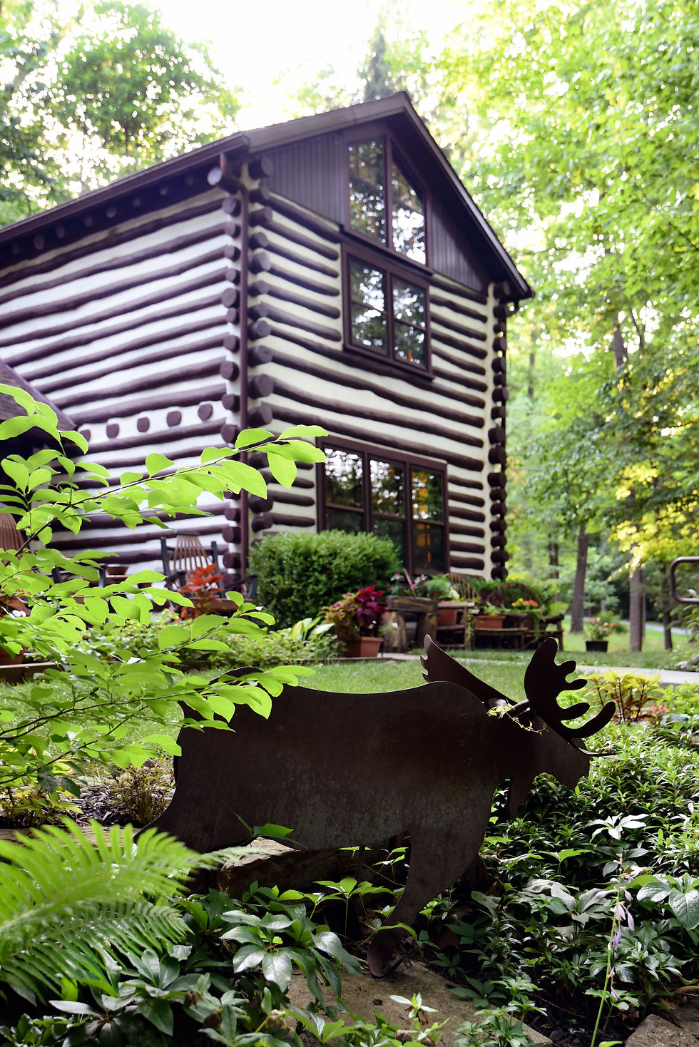 The cabin exterior, including a moose in keeping with cabin's theme. Photo by Shannon Fretz Photography.