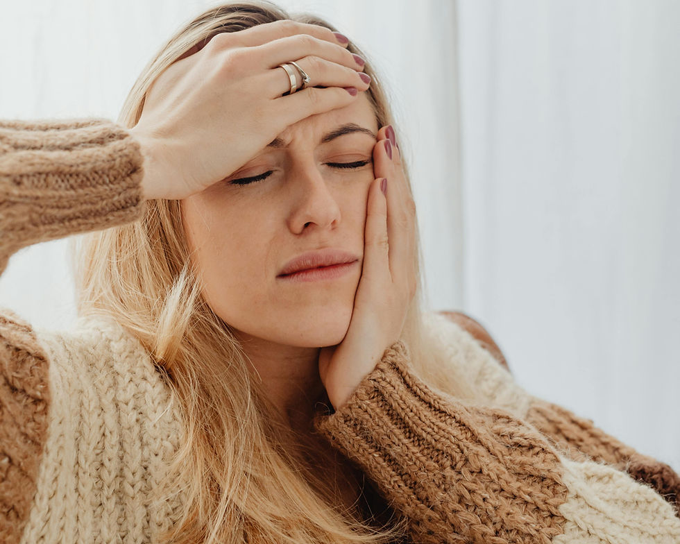 A woman covering her face with both hands, practicing calming hand therapy for stress and emotional relief during winter.