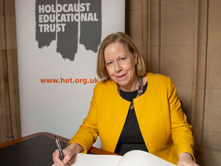 A picture of Ruth Cadbury MP signing the Holocaust Memorial Day