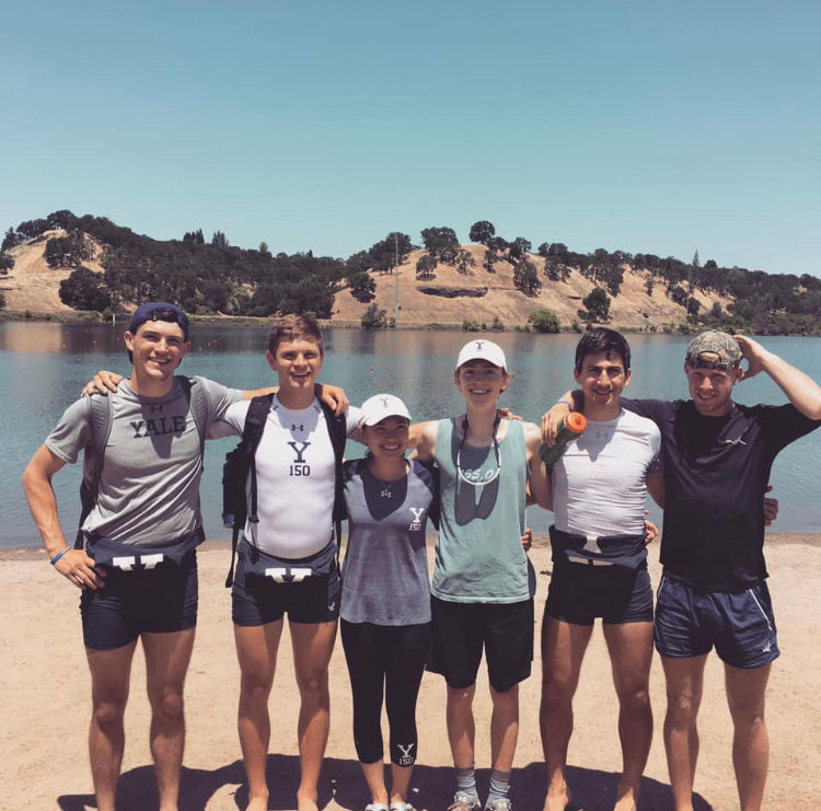 Quentin Geczy with friends standing by a body of water