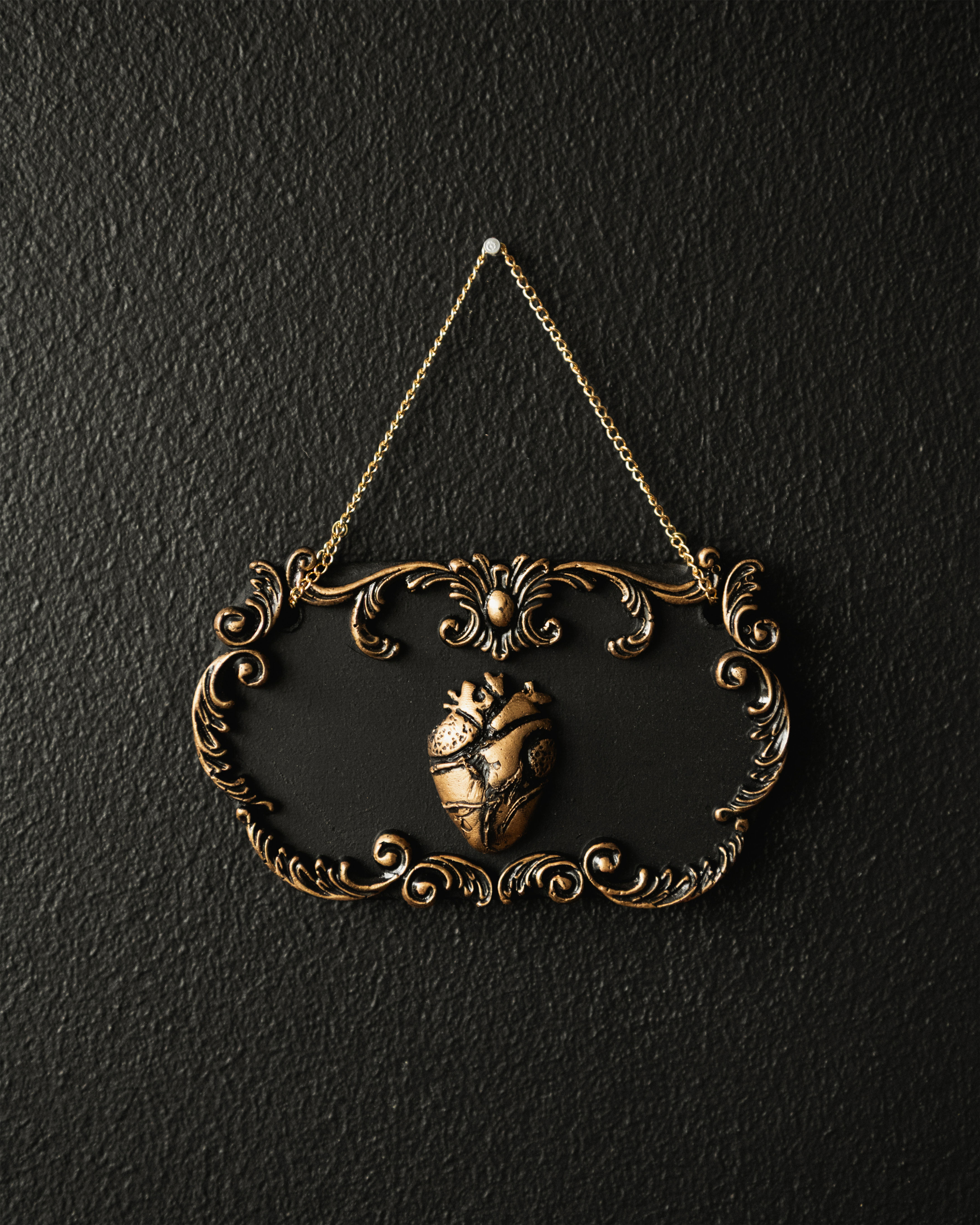 Anatomical heart wall hanging with an ornate baroque frame, silver or gold finish, velvet backing and hanging chain.