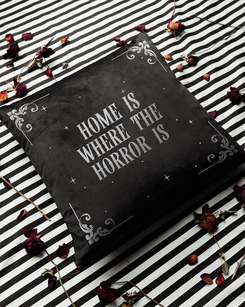 Thumbnail: Black cushion with Victorian corner flourishes, small stars and gothic text reading 'home is where the horror is'