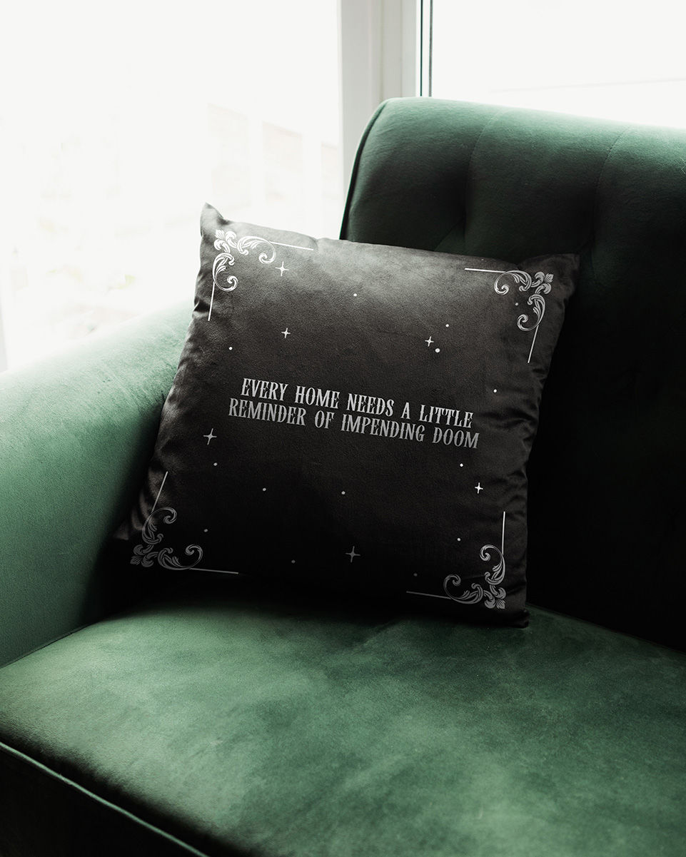Thumbnail: Impending doom gothic cushion displayed on a dark forest green sofa