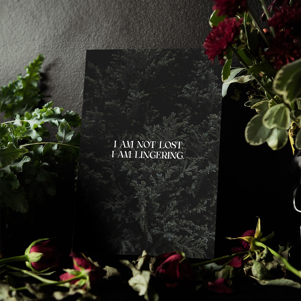 A print of a photo of dark, dense evergreen foliage with centred serif text that says “I am not lost. I am lingering.”