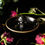 Thumbnail: Glossy black trinket dish with a gold rim and accents, with a black and gold skull in the centre.