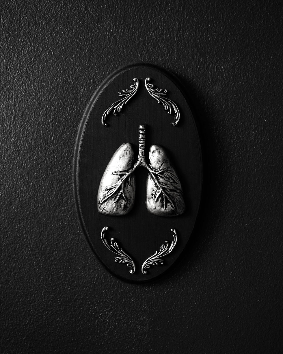 Thumbnail: Oval gothic wall plaque with raised lungs sculpture and ornate flourishes mounted on a black MDF backing.