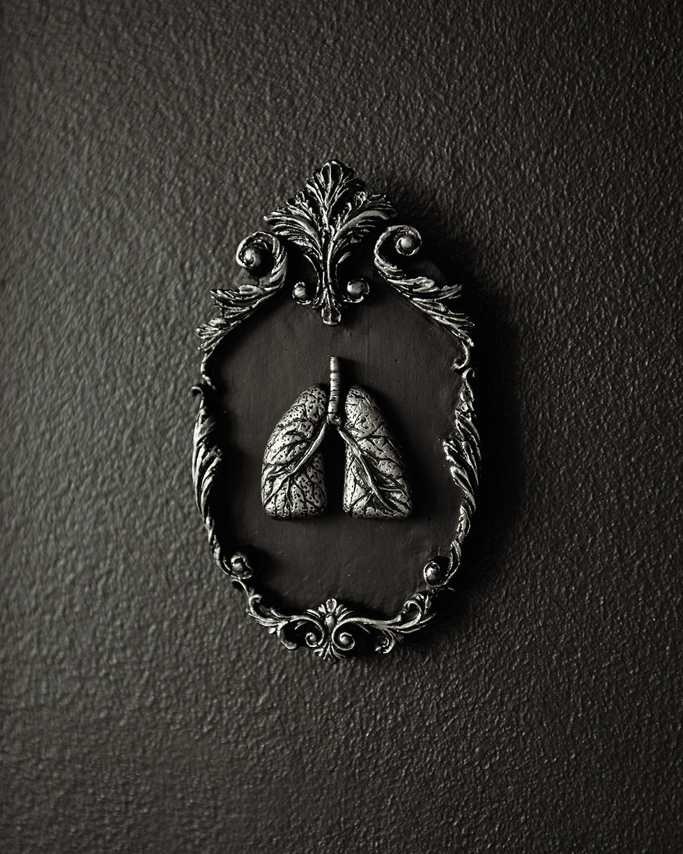 Handmade gothic wall plaque featuring a miniature sculpted pair of lungs inside an ornate oval baroque-style frame.