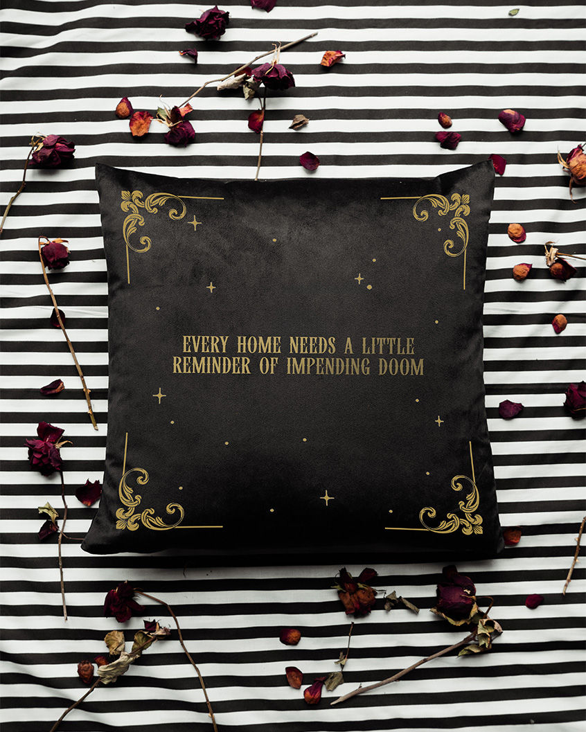 Thumbnail: Black cushion with victorian flourishes, stars and gothic text reading "Every Home Needs a Little Reminder of Impending Doom"