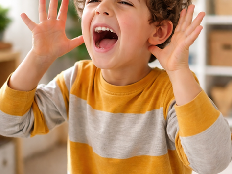 Young child expressing excitement indoors with hands raised