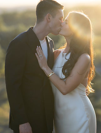 Couple kissing outdoors at sunset; family and couple photoshoot.