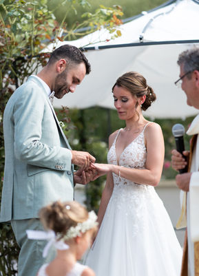 the groom slips the ring onto the bride's finger
