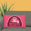 Thumbnail: Pink-Green Seriously Colorful Cool Cat Pillow showing pink side with cat design on a dark couch