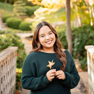 a fall senior session, girl holding leaf