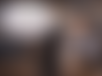 Cafe owner serving a customer while comparing revenue and profit in a busy hospitality venue