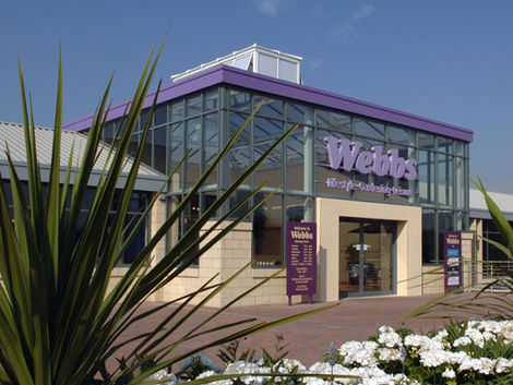 Webbs garden centre, retail store entrance, purple signage, welcoming entrance, sunny day.
