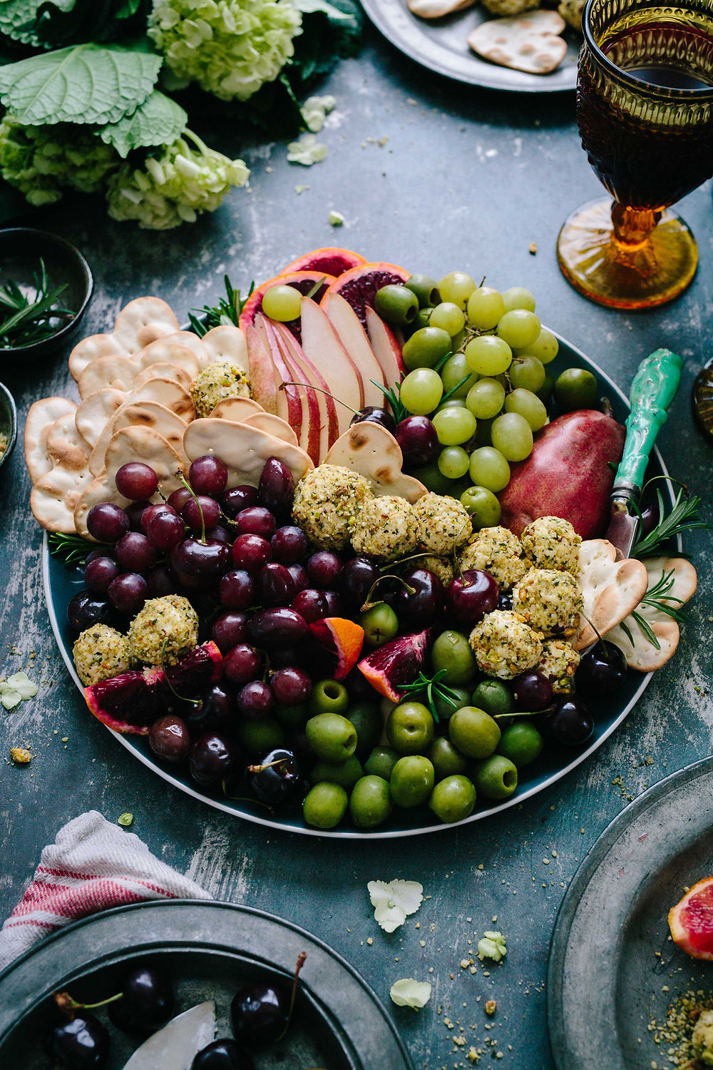 Vibrant grazing platter with red and green grapes, apples