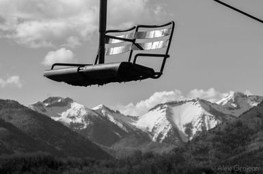 a chairlift with mountains in background