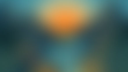 a river flowing between mountains and a sun