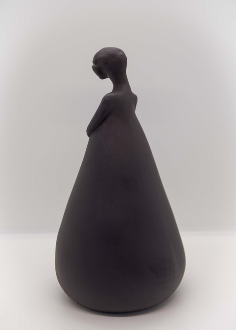 Hand modelled ceramic sculpture of human figure with cone shaped body, black stoneware.