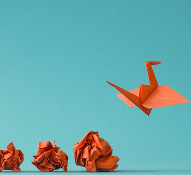 New ideas or transformation concept with crumpled paper balls and a crane, teamwork, creat