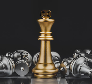 Victory. shot of golden king stand with silver chess pieces on chess board game competitio