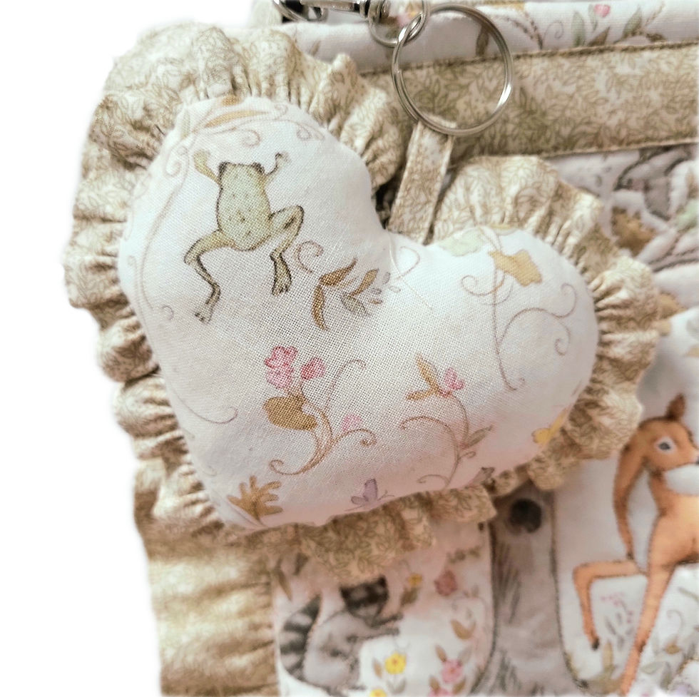 Thumbnail: reverse side of heart shaped bag charm in woodland animal print in soft earthy colours