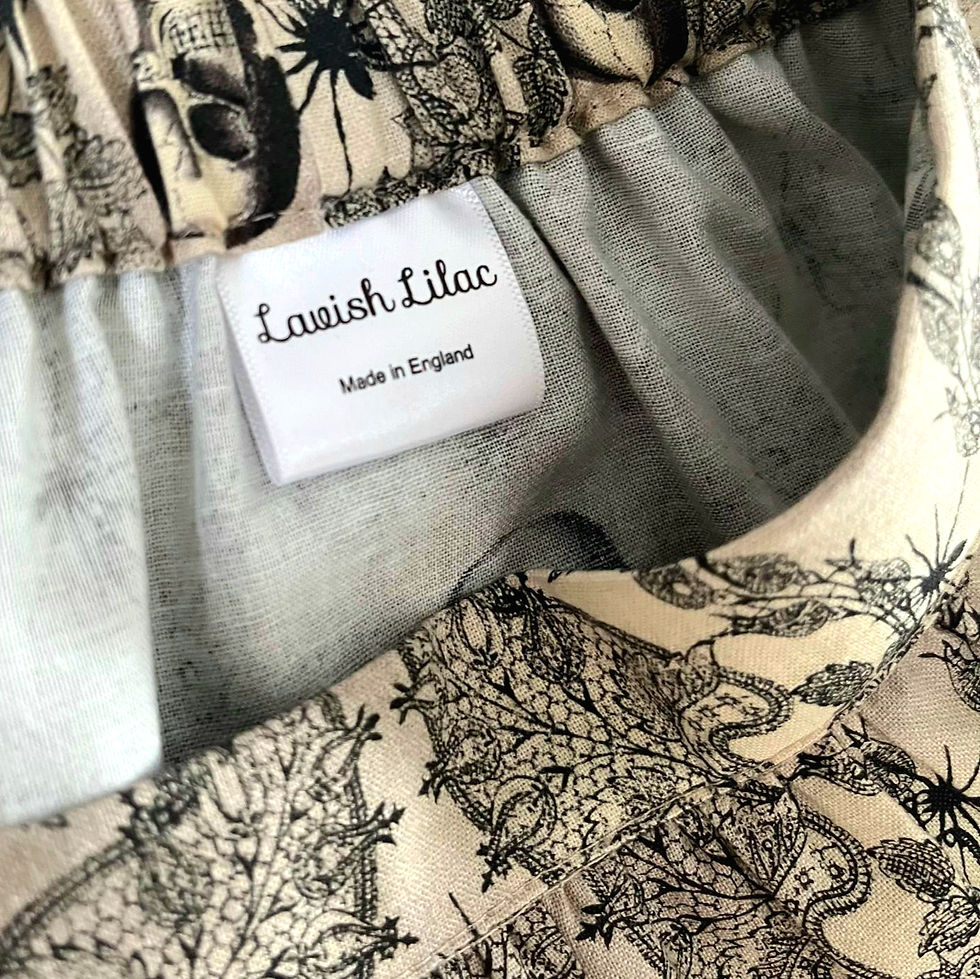 Thumbnail: close up of Lavish Lilac label in skirt in skulls and lace print in colours of vintage beige and black