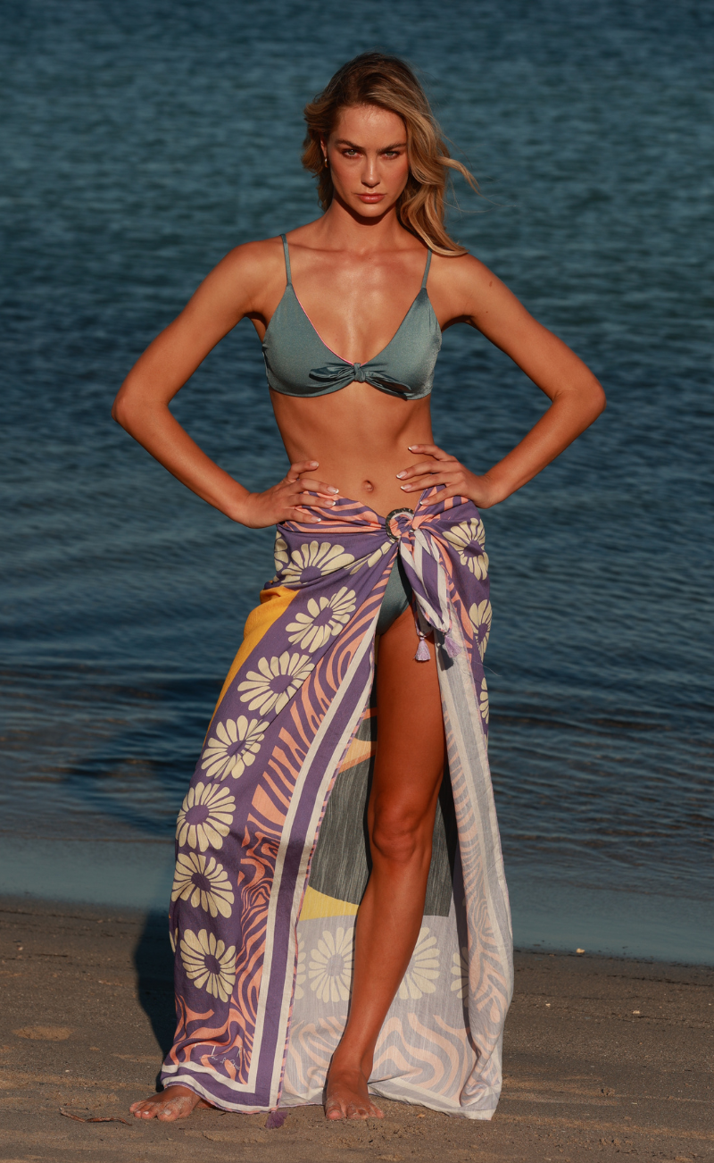 Square beach sarong with handmade pom poms laid flat