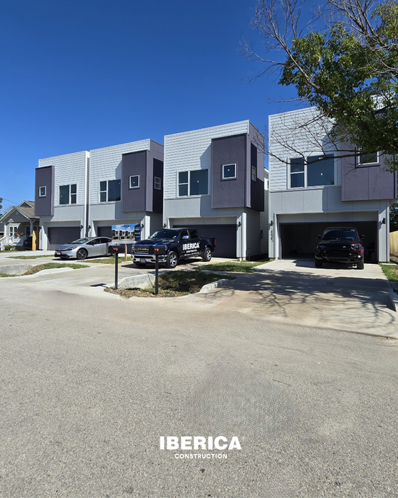 The exterior showcases clean architectural lines with a mix of stucco panels and siding. This modern Houston facade blends durability with eye-catching design.