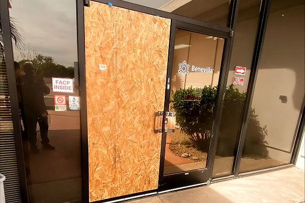 Boarded-up door break-in