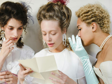 three women reading a letter for world poetry day