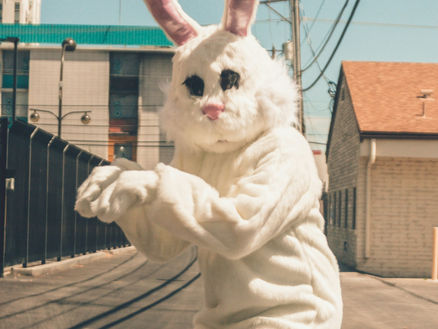 person in a giant bunny costume on the street