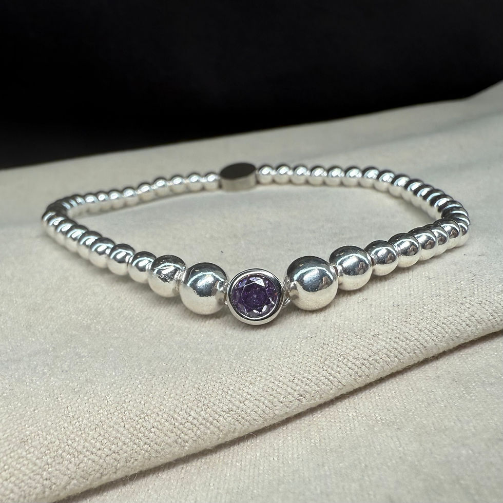 Thumbnail: Handmade stackable beaded bracelet featuring polished beads and a purple round charm on a comfortable stretch band