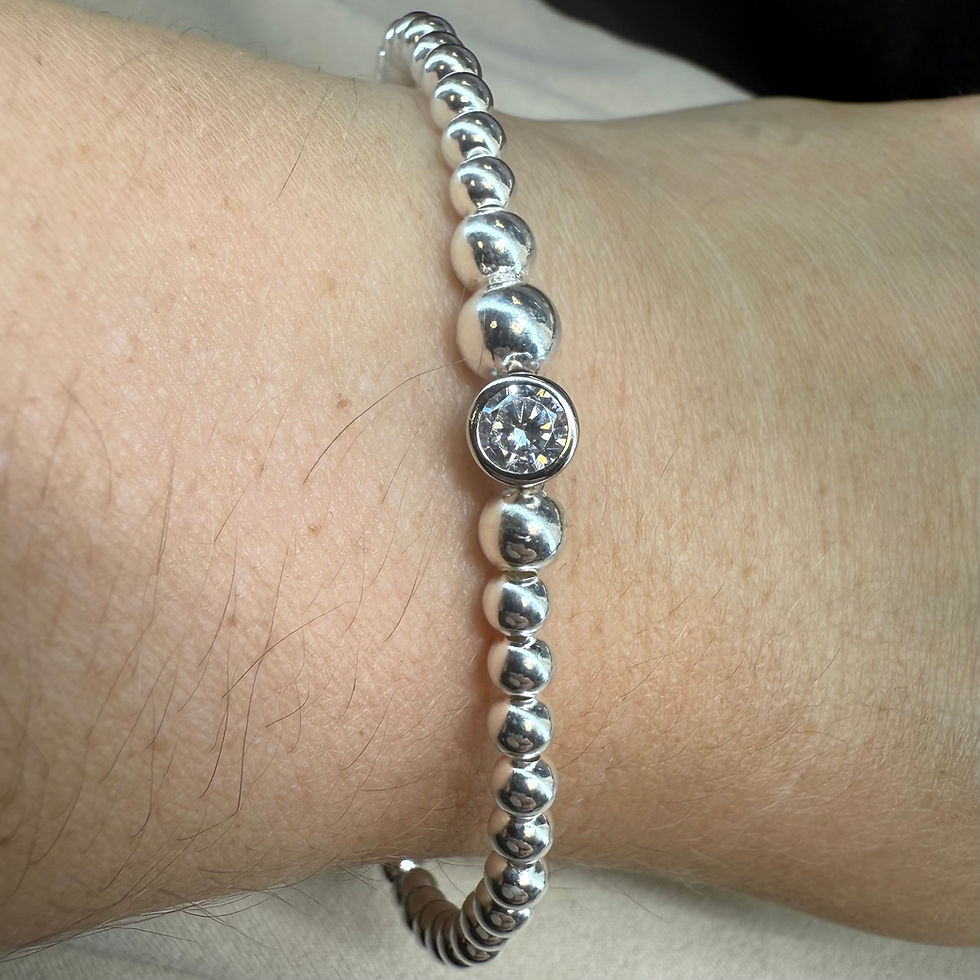 Thumbnail: Handmade silver beaded stackable bracelet with a sparkling clear round charm,