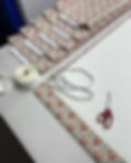 Fabric being measured and prepared for bespoke curtains at Ashley Interiors, showing tailoring tools and patterned material in the Denby Dale workshop.