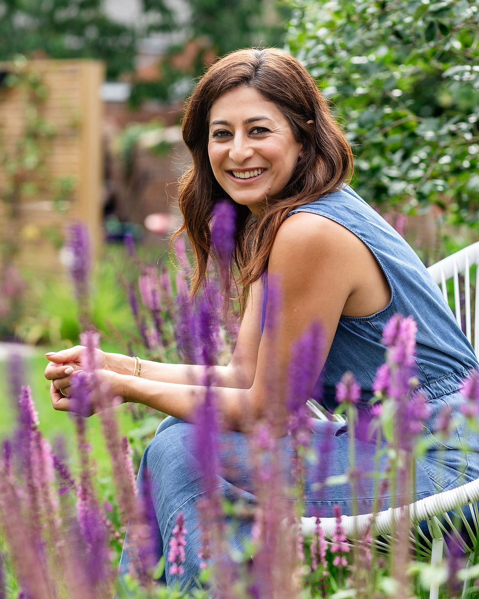 Philippa, founder of Philippa Ann Interiors, sitting in a garden