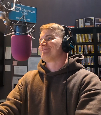 Jamie smiling while behind the mic at 99.5 WCRB