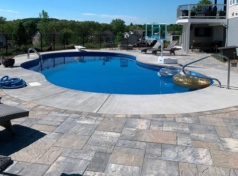 New inground pool, deck and patio in Fairport NY. Designed by Rochester Landscape Designs.